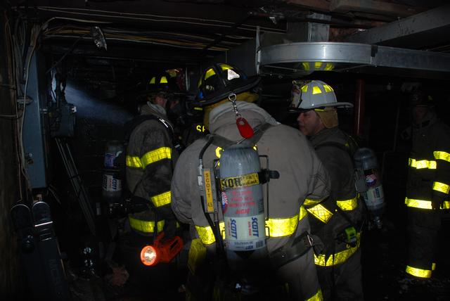 Members in the basement checking for fire extension.