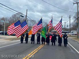 The Southold FD Honor Guard marches in the Cutchogue FD's St. Patty's Day Parade on Route 25.