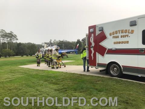 Members returning empty stretcher to ambulance